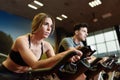 Couple in a spinning class wearing sportswear. Royalty Free Stock Photo