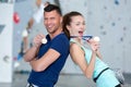 couple in sport gear holding medals