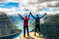 Couple standing against amazing nature view on the way to Trolltunga. Location: Scandinavian Mountains, Norway, Stavanger. Artist