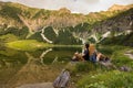 Couple standing back to back in beautiful nature landscape / Young couple in love standing back to back