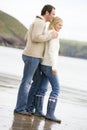 Couple standing on beach smiling Royalty Free Stock Photo