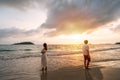 Couple standing on the beach at sunset are having problems with each other Royalty Free Stock Photo