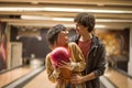 Couple standing in a bowling alley and holding a ball together. Royalty Free Stock Photo