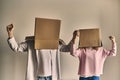 Couple with cardboard boxes in new house. Young happy couple with cardboard boxes on their heads happy his new home Royalty Free Stock Photo