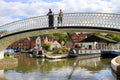 Couple standing on bridge by canal marina