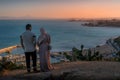 The couple standing on the cliff edge at Sidi Bou Said, watching down on the Mediterranean Sea in the Tunis city. Royalty Free Stock Photo