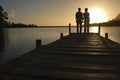 Couple standing on dock by lake holding hands back view Royalty Free Stock Photo