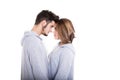 Couple standing face-to-face in white studio