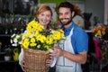 Couple standing with flower basket Royalty Free Stock Photo