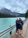 A couple standing in front of the Emerald Lake in Yoho National Park in Canada