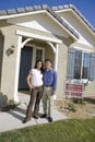 Couple Standing In Front Of New House Royalty Free Stock Photo