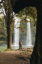 A couple standing in front of waterfall in New Zealand