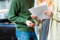 Couple standing holding paper keys.