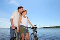 Couple standing by the lake with bikes Royalty Free Stock Photo