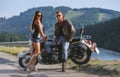 Couple standing by a motorbike Royalty Free Stock Photo