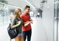 Couple is standing near map and choosing route