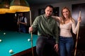 happy caucasian couple standing near the pool billiard table Royalty Free Stock Photo