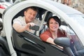 Couple standing near twizy electric