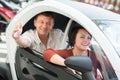 Couple standing near twizy electric