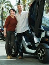Couple standing near twizy electric