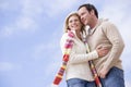 Couple standing outdoors smiling