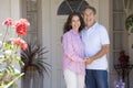 Couple Standing Outside Their House