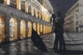 Couple standing in the raining street