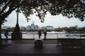 Couple standing at the river Thames railing enjoying the view
