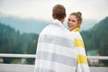 Couple standing on terrace and looking at mountains. Royalty Free Stock Photo