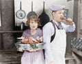 Couple standing together in a kitchen with a cooked turkey