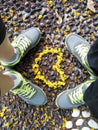 Couple standing with yellow flowers forming love shape in center