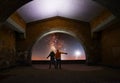 Couple stands under arch in the night. Couple in love looks at the bright milky way galaxy.