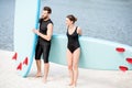 Couple with standup paddleboard on the beach