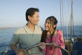 Couple at steering wheel of sailboat Royalty Free Stock Photo