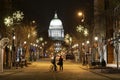 Couple in street looking at Capitol on a snowy evening in Madison, WI