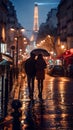 Couple in the streets behind umbrella. Honeymoon in Paris, against Eiffel tower