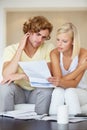 Couple, stress for bills and reading documents on sofa with debt, financial planning or budget risk and worry at home Royalty Free Stock Photo