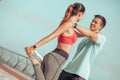 Couple stretching legs after workout together outdoors Royalty Free Stock Photo