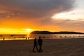 Couple strolling on the beach during sunset