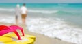 Couple strolling past flip flops Royalty Free Stock Photo