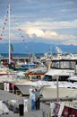 Couple strolls among boats moored at a marina.