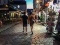 Couple strolls nighttime Montmartre cobblestone street Royalty Free Stock Photo