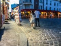 Couple strolls past tourist print shop on Montmartre, Paris, France