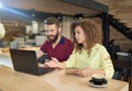 Couple of students studying in cafe using laptop. Royalty Free Stock Photo