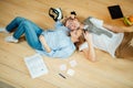 Couple studying while lying on floor at home Royalty Free Stock Photo