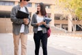 Couple of students are walking in university during break and communicating Royalty Free Stock Photo