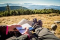 Couple at outdoor Bible study during mountain hike in the fall Royalty Free Stock Photo