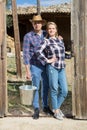 Couple of farmers standing near wooden fence