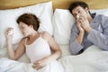 Couple Suffering From Colds In Bed Royalty Free Stock Photo