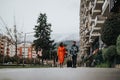 Couple with suitcase walking by city apartments, travel lifestyle Royalty Free Stock Photo